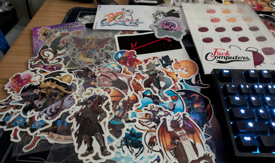 A small pile of stickers strewn about a desk.